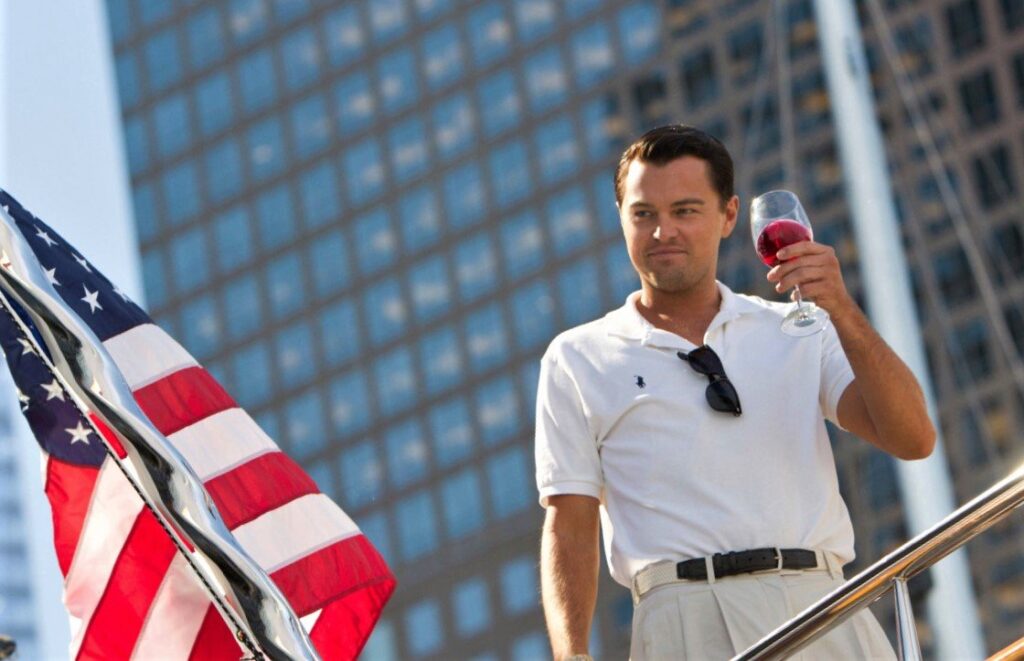 Leonardo DiCaprio holding a glass of wine on his Yacht in the 2013 film The Wolf of Wall Street.