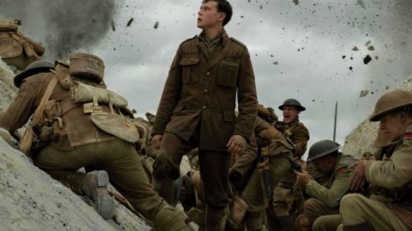Soldier standing in chaos of WWI in a WWI movie.
