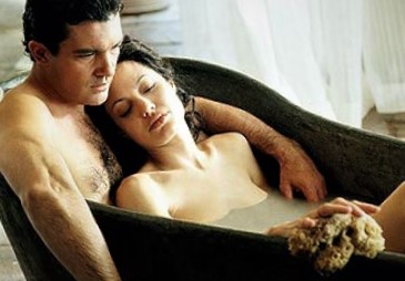 Angelina Jolie lying naked in bath tub.
