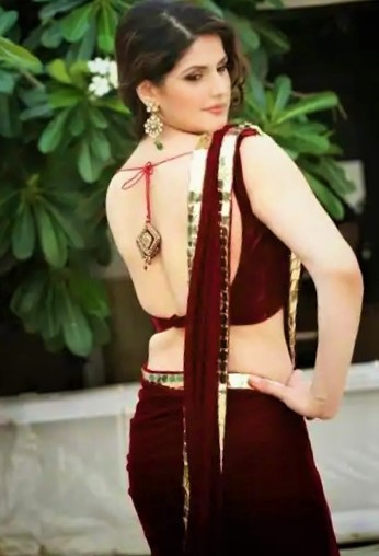Indian actress Zareen Khan showing naked back in Maroon Saree.